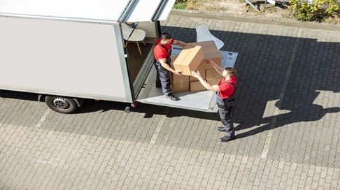 People packing boxes into moving truck