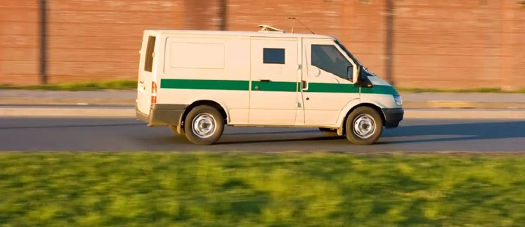 A white van driving on the road